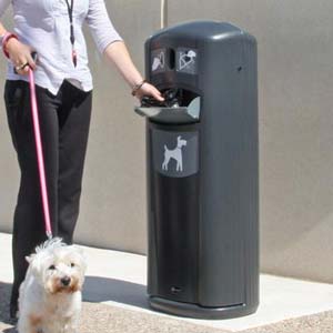 Dog owner using the Retriever City Pet Waste Station with dog on lead