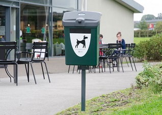 Fido™ Pet Waste Station green post mounted outside café