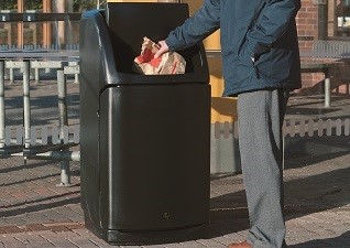 Nexus® 36G Restaurant Trash Can with aperture flap in black outside McDonald’s fast food drive thru