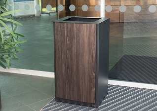 Nexus® Style Duo Recycling Bin with dark teak vinyl wrap in hotel lobby