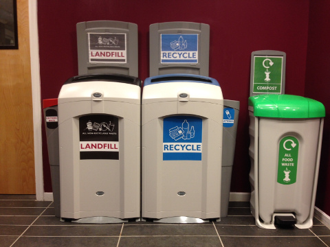 Nexus 26G Trash and Mixed Recycling Bins alongside Nexus Shuttle in college hallways.