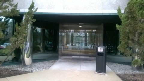 Integro™ City Ash and Trash Can outside a building entry point