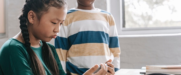 Two students watching a video on a mobile phone