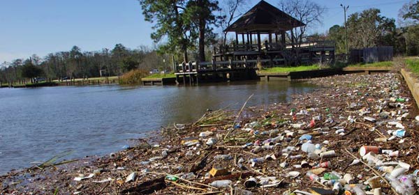 Plastic litter discarded onto a river bank